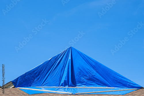 Blue Tarp Protecting Hurricane Damaged Roof photo