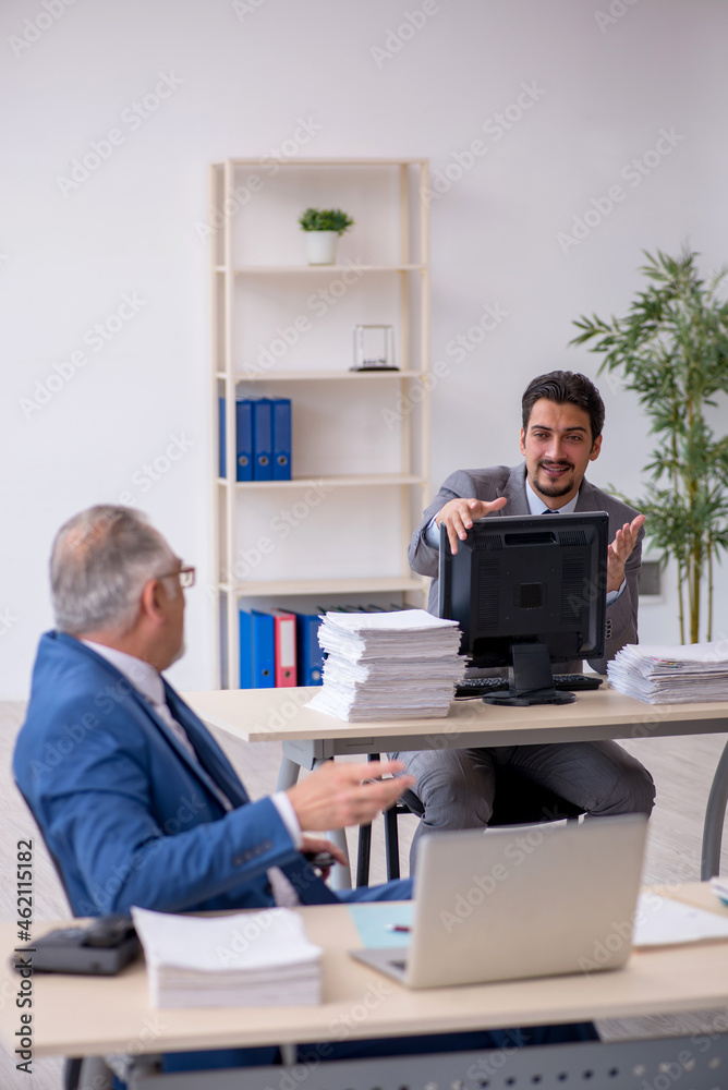 Two male colleagues working in the office Two male colleagues working in the office