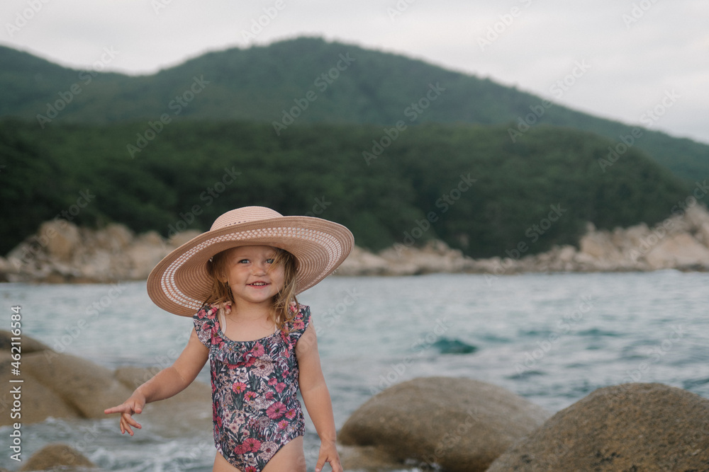 smiling girl on the sea in a hat