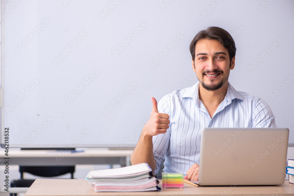 Young male teacher in front of whiteboard Young male teacher in front of whiteboard