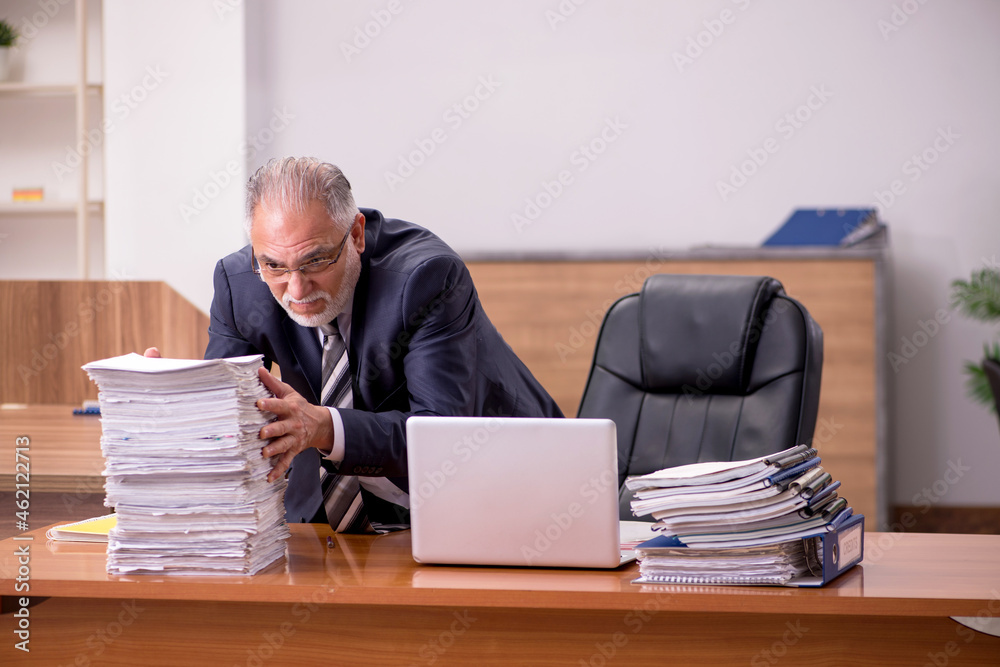 Old male employee and too much work in the office Old male employee and too much work in the office