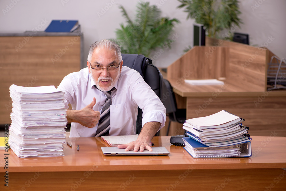 Old male employee and too much work in the office Old male employee and too much work in the office