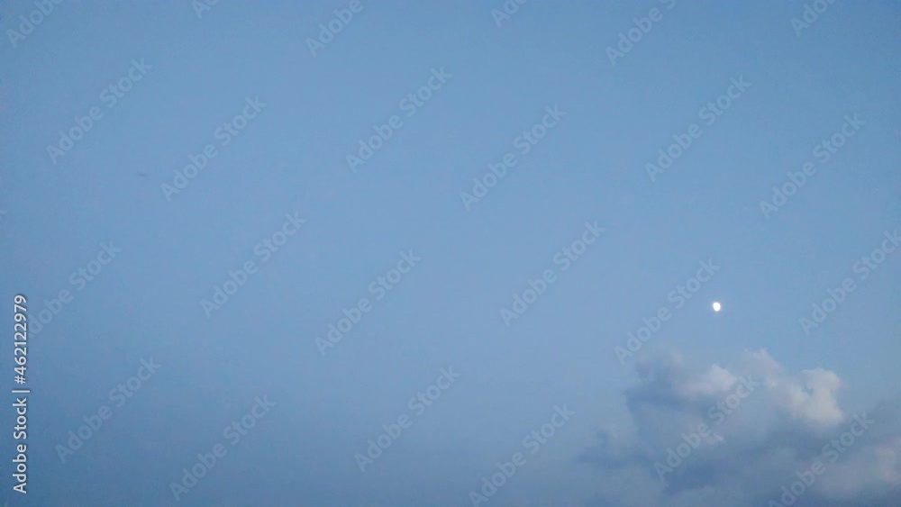 Timelapse of the sky getting darker during nightime and revealing the moon