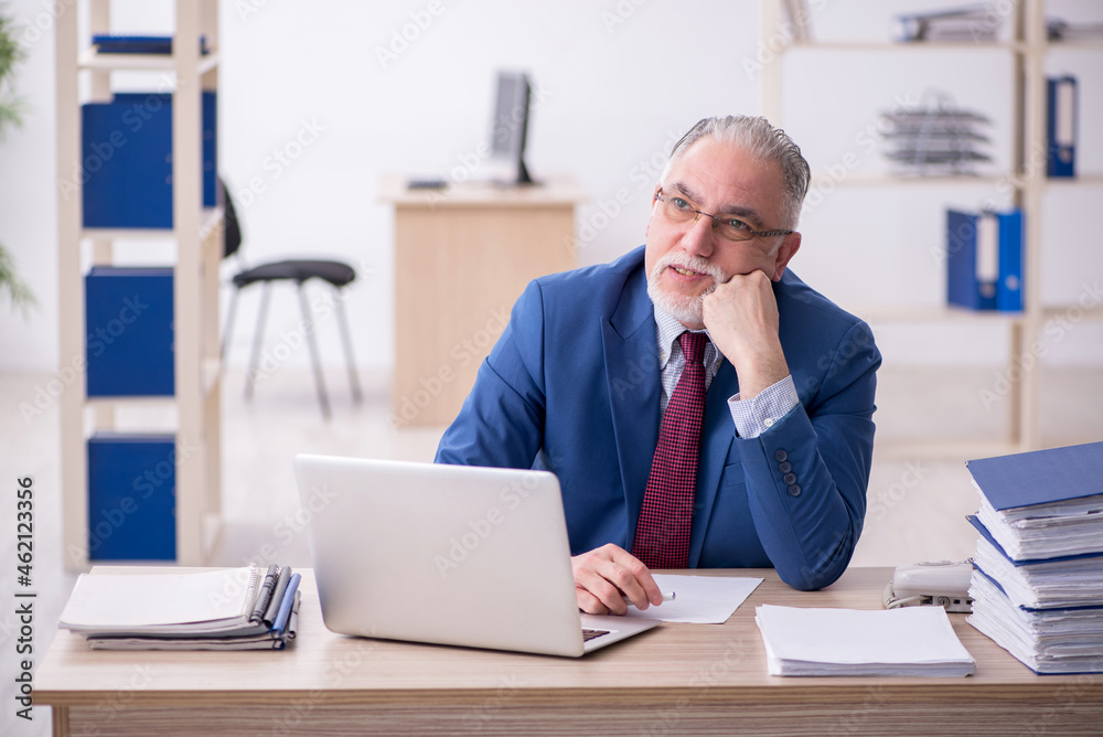 Old male employee and too much work in the office Old male employee and too much work in the office