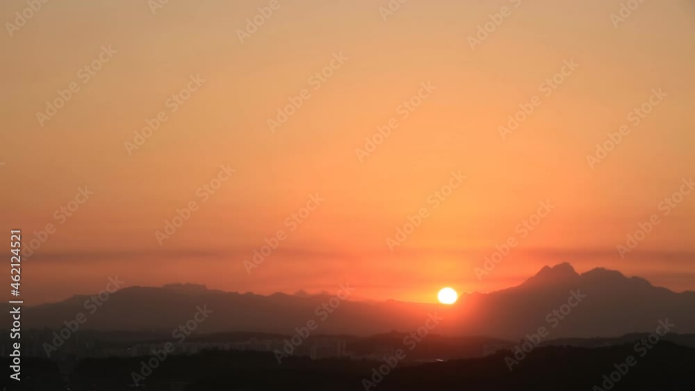Time lapse of rising sun over mountains Time lapse of rising sun over mountains