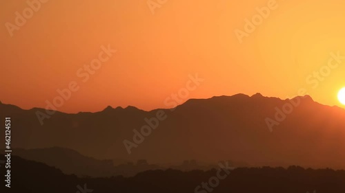 Time lapse of rising sun over dark clouds