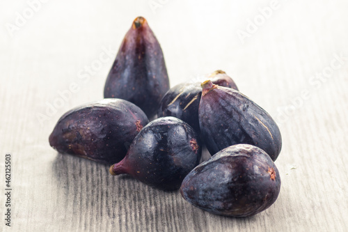 Fresh whole figs, on white wooden table.