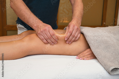 Woman getting legs lymphatic drainage massage in spa salon. Closeup. Body relaxation beauty and body care concept.