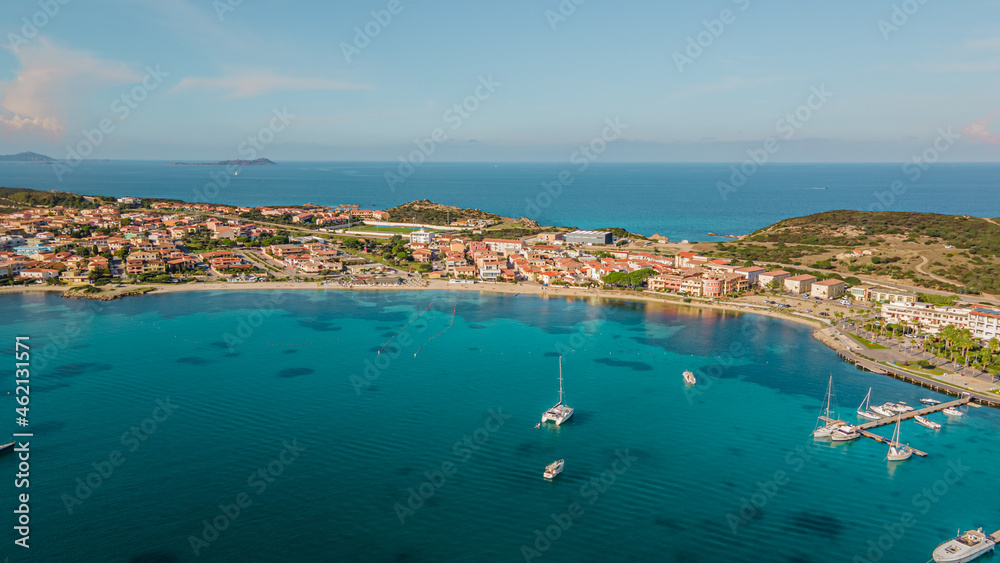 Obraz premium the picturesque coastal village of Golfo Aranci in northern Sardinia. perfect for vacations, beautiful beaches, clear blue water. Boats and yachts anchored on the jetty. drone aerial view Italy.