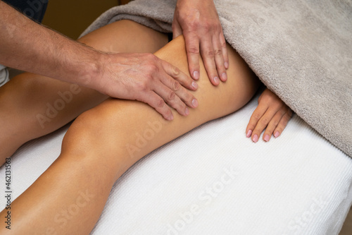 Woman getting legs lymphatic drainage massage in spa salon. Closeup. Body relaxation beauty and body care concept.