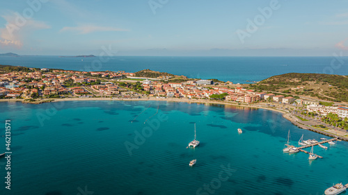 the picturesque coastal village of Golfo Aranci in northern Sardinia. perfect for vacations, beautiful beaches, clear blue water. Boats and yachts anchored on the jetty. drone aerial view Italy.
