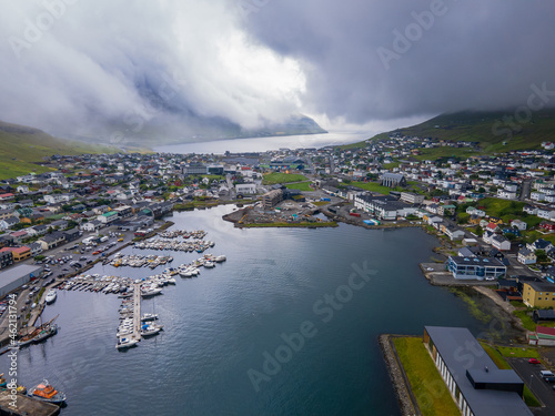 Beautiful aerial view of the City of Klaksvik in the Fareo Islands with its colorful houses and amazing canal and view to the majestic Kunoy Park photo