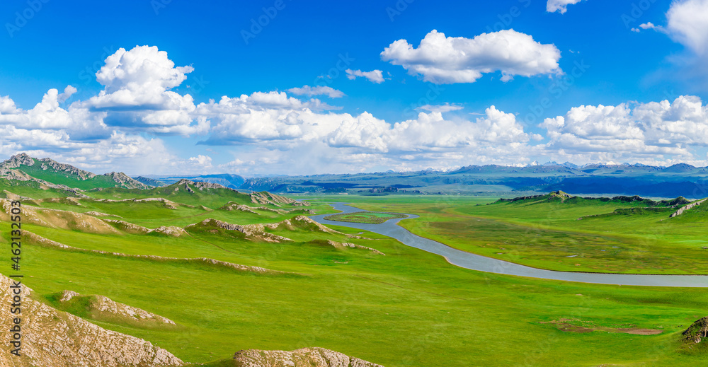 Bayinbuluke grassland natural scenery in Xinjiang,China.The winding river is on the green grassland.Panoramic view.