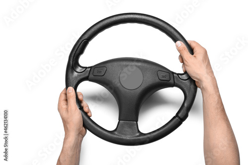 Man holding modern steering wheel on white background © Pixel-Shot