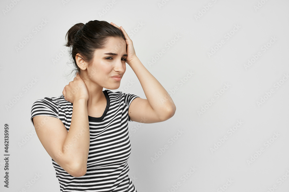 brunette in a striped t-shirt pain in the neck health problems brunette in a striped t-shirt pain in the neck health problems
