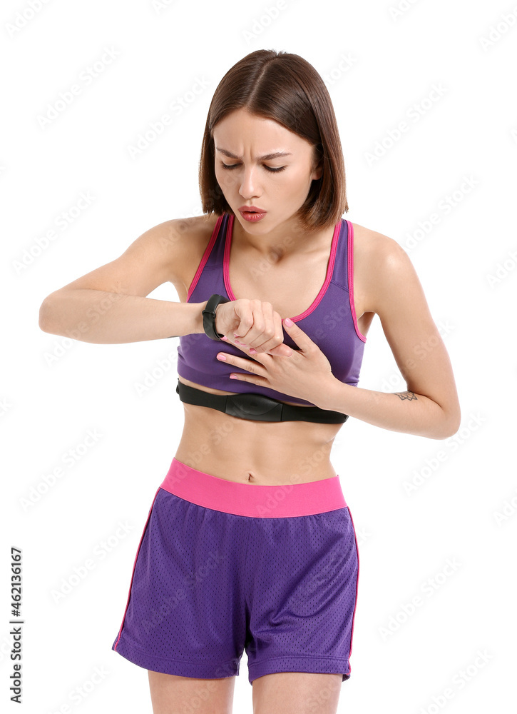 Sporty female runner checking pulse on white background Sporty female runner checking pulse on white background