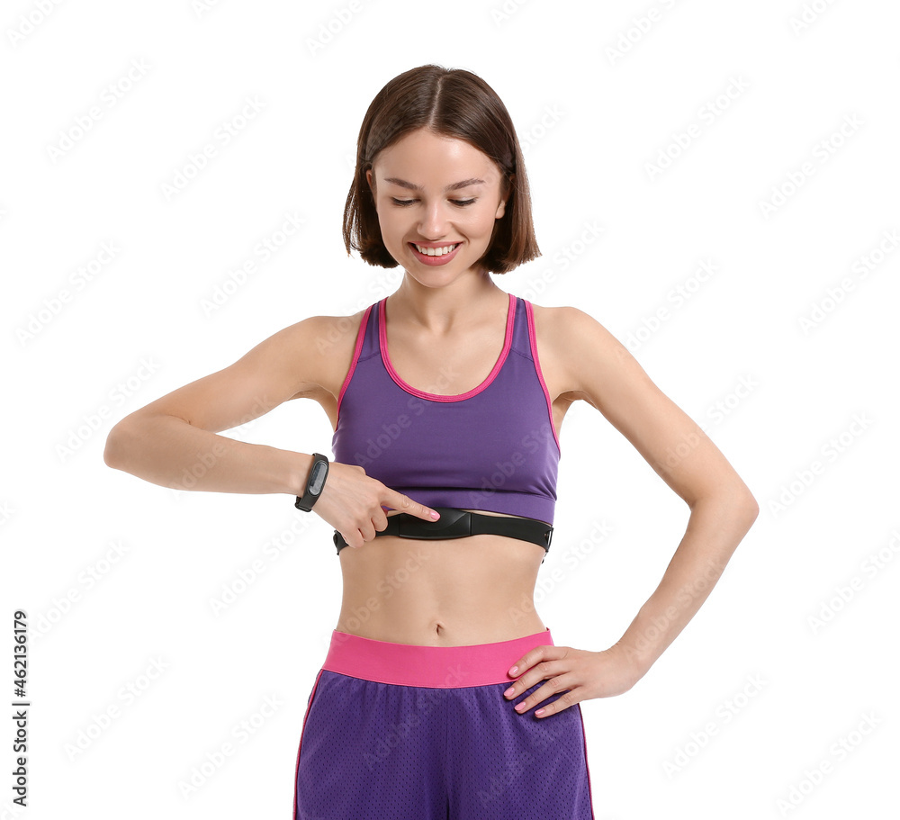 Sporty female runner checking pulse on white background