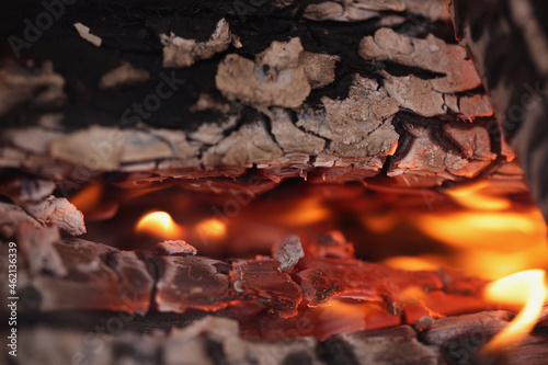Blazing charcoal grill with bright flame of fire closeup