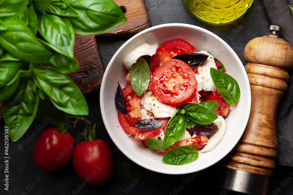 Caprese salad with fresh tomatoes, basil and mozzarella cheese Caprese salad with fresh tomatoes, basil and mozzarella cheese