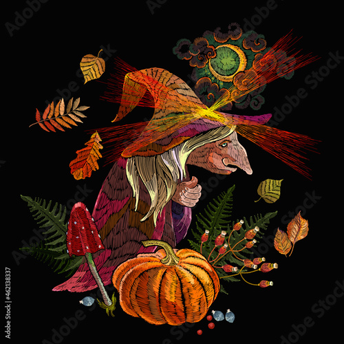 Old witch wearing hat. Halloween background. Forest sorceress, orange pumpkins, autumn leaves, moon and fly agarics. Witchcraft. Romantic dark gothic fairy tale art. Embroidery style