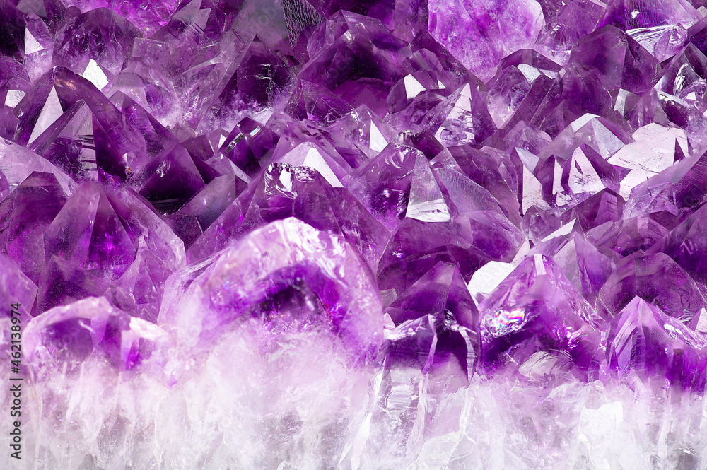A shiny, purple nugget of amethyst shot with a great depth of field very close-up A shiny, purple nugget of amethyst shot with a great depth of field very close-up