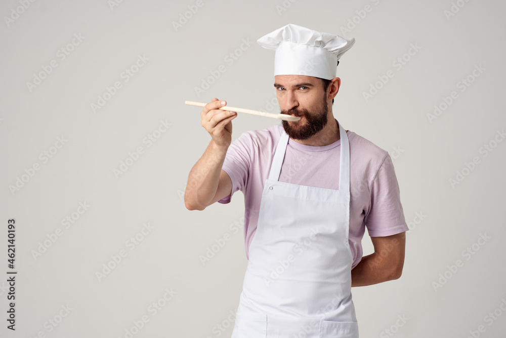male chef with a cap on his head tasting food professional cooking male chef with a cap on his head tasting food professional cooking