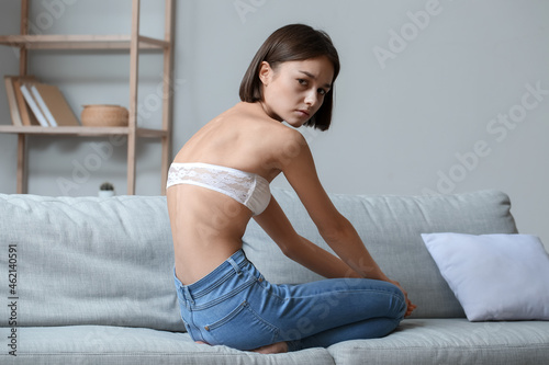 Young woman with anorexia at home photo