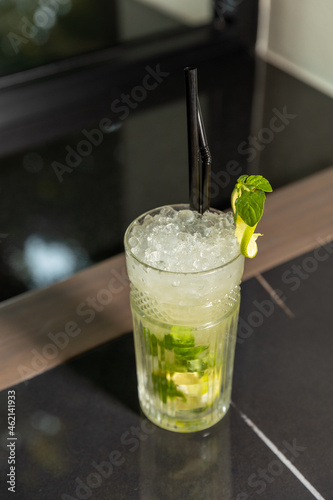 Mojito cocktail in a glass on a marble counter