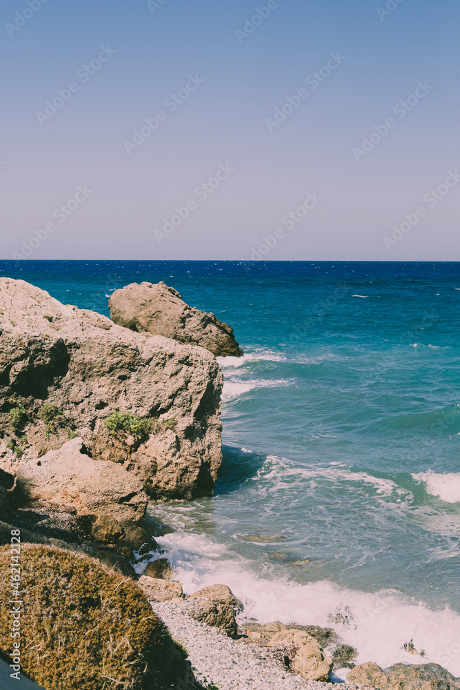 Islands Ocean Tropical Beach Landscape. View on water with waves, cliffs and rocks.