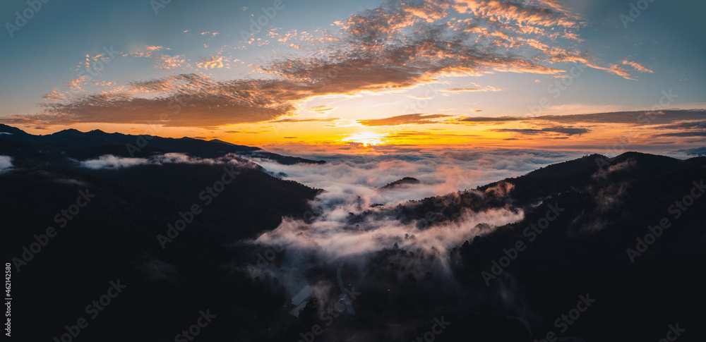 The sun rises in the mist and mountains in the morning The sun rises in the mist and mountains in the morning