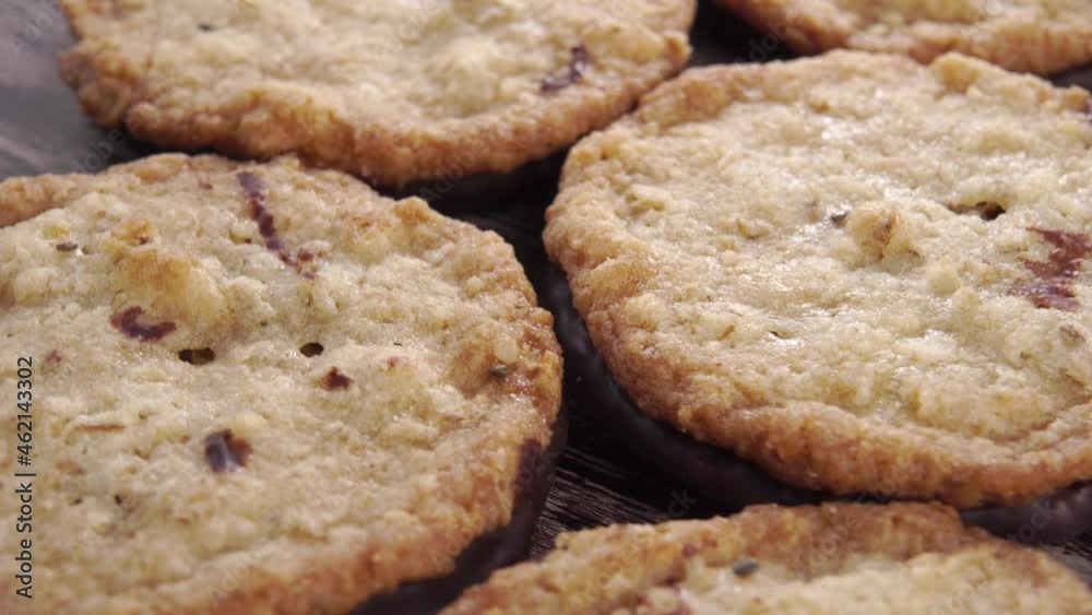 Homemade oatmeal cookies with chocolate on a wooden old table close-up. Rotation Homemade oatmeal cookies with chocolate on a wooden old table close-up. Rotation