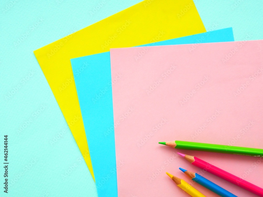 Colored paper and pencils top view Colored paper and pencils top view