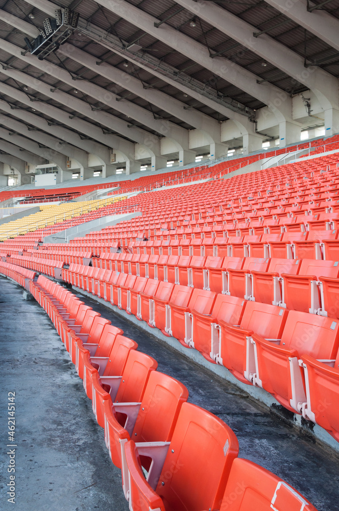 Naklejka premium Empty orange seats at stadium,Rows walkway of seat on a soccer stadium