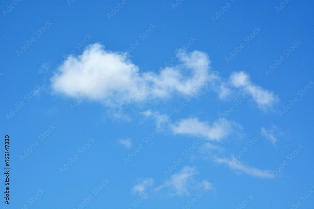 White clouds against clear blue sky for background or template White clouds against clear blue sky for background or template