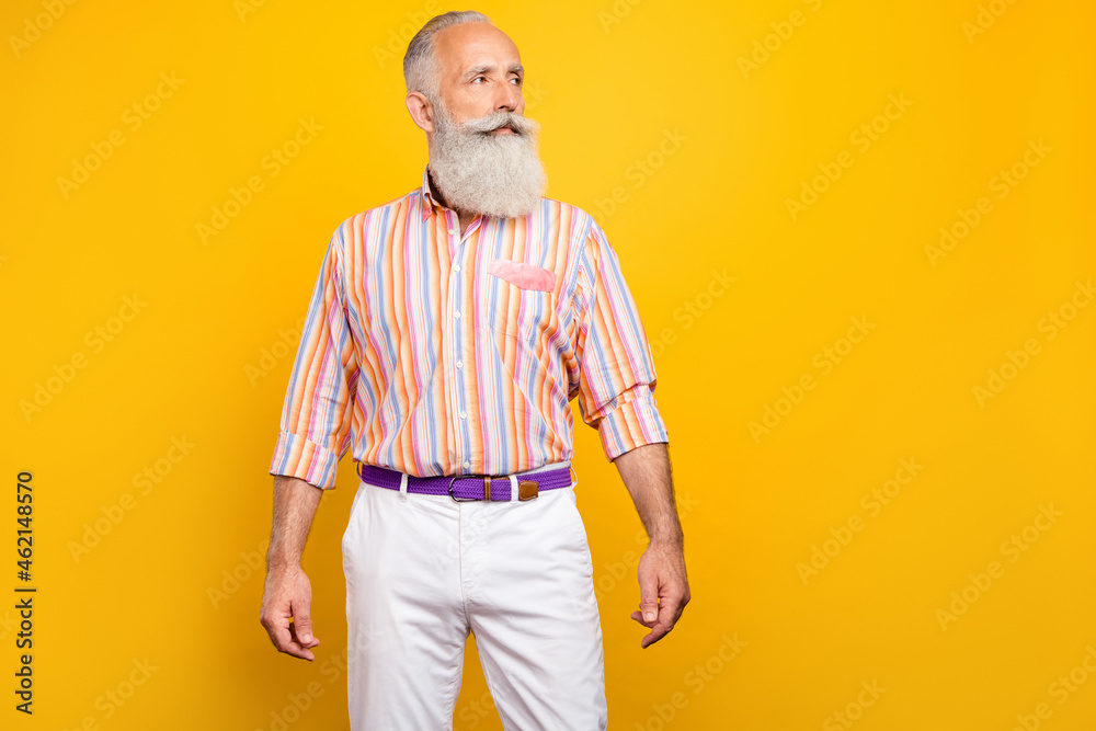 Photo of cool self-assured bearded old man look empty space wear striped shirt isolated yellow color background Photo of cool self-assured bearded old man look empty space wear striped shirt isolated yellow color background