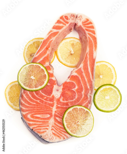 Steak of red fish and lenon. Steak of red fish and sliced lemons on white photo