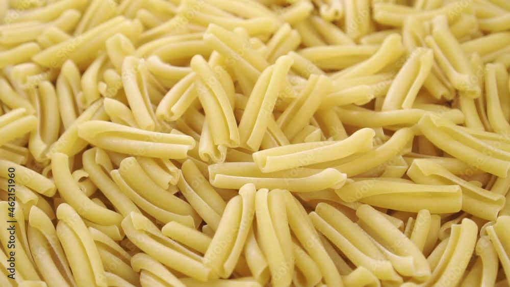 Traditional Italian pasta casarecce. Close up. Rotation. Dry uncooked macaroni Traditional Italian pasta casarecce. Close up. Rotation. Dry uncooked macaroni