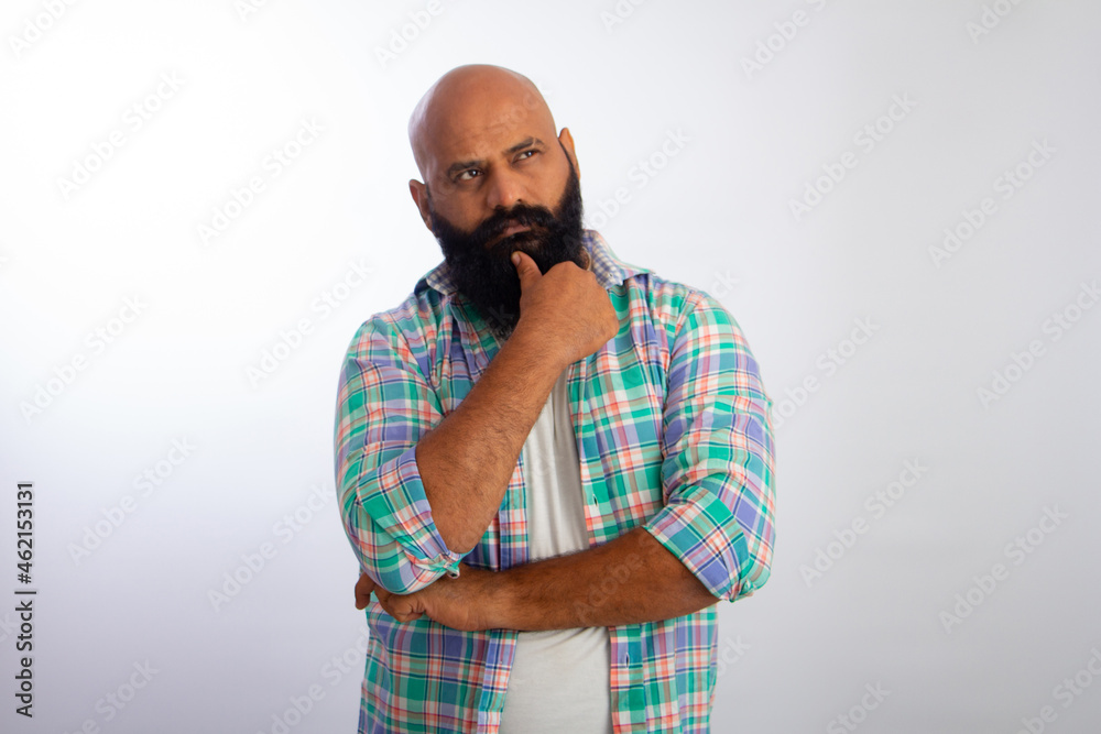 Indian Strong Healthy middle aged bald man looking up and thinking. Indian Strong Healthy middle aged bald man looking up and thinking.