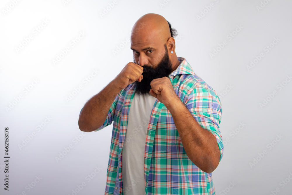 ndian Strong Healthy middle aged bald man Punching fist to fight, aggressive and angry attack, threat and violence