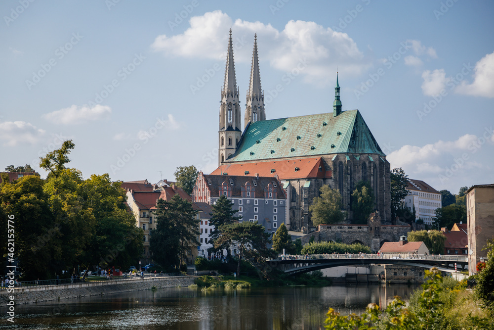 Goerlitz, Germany, 04 September 2021: gothic medieval St. Peter and Paul Church or Peterskirche with two white towers in historical center of city at sunny summer day, Riverbank of Lusatian Neisse