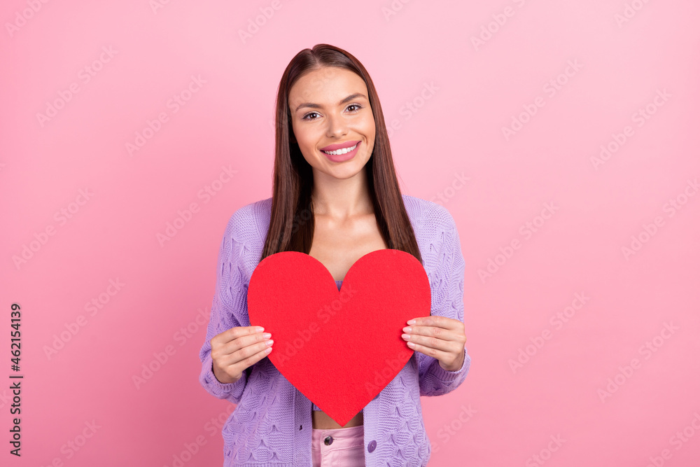 Photo of romantic lady hold red paper heart figure card wear violet cardigan isolated pink color background Photo of romantic lady hold red paper heart figure card wear violet cardigan isolated pink color background