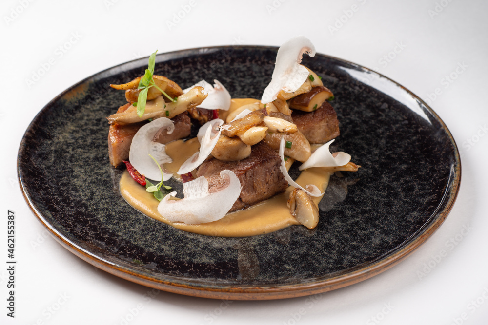 Lunch steak meat with vegetable cream and mushrooms, high cuisine, restaurant food in menu
