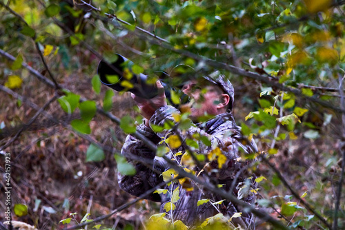 professional photographer in camouflage clothes working in nature.