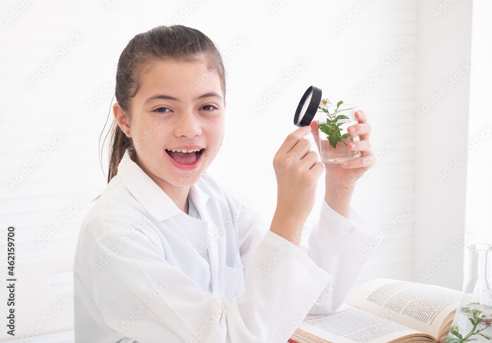 Lovely little girl scientist making experiments in the laboratory. Concept of good practice and education of science for children support. Lovely little girl scientist making experiments in the laboratory. Concept of good practice and education of science for children support.