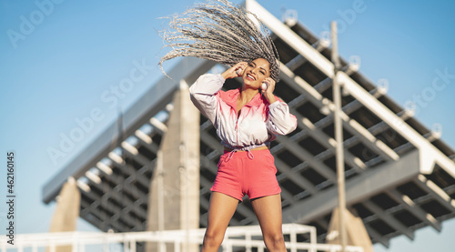 Smiling woman tossing hair during sunny day