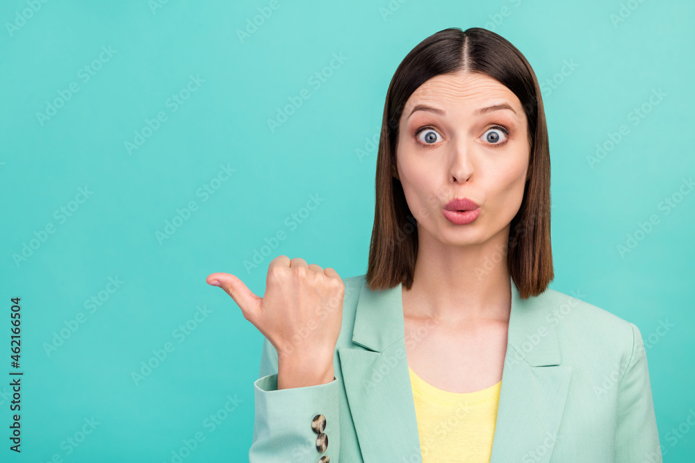 Photo of impressed young brunette lady point empty space wear blazer isolated on aquamarine color background Photo of impressed young brunette lady point empty space wear blazer isolated on aquamarine color background