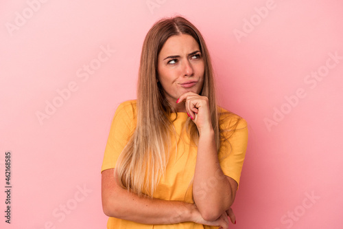 Young Russian woman isolated on pink background raising fist after a victory, winner concept.