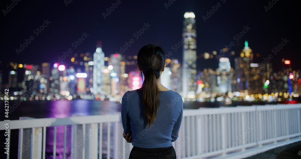 Woman look at the Hong Kong city at night