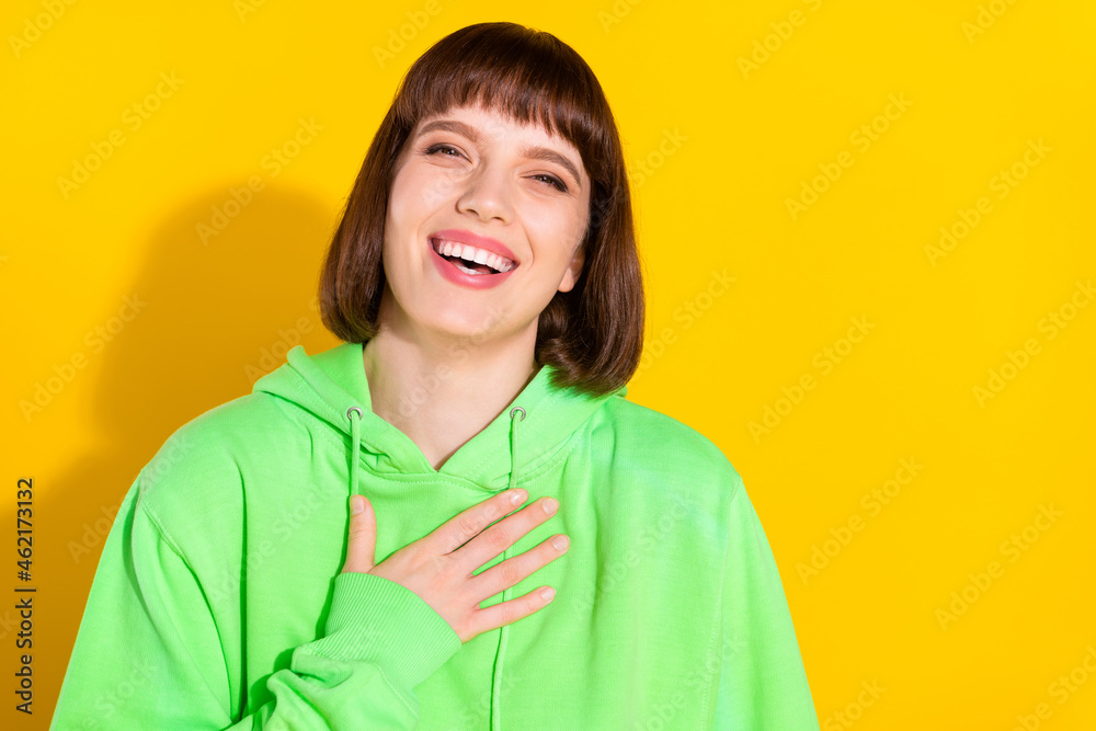 Portrait of attractive cheerful girl laughing funny joke good news isolated over bright yellow color background Portrait of attractive cheerful girl laughing funny joke good news isolated over bright yellow color background