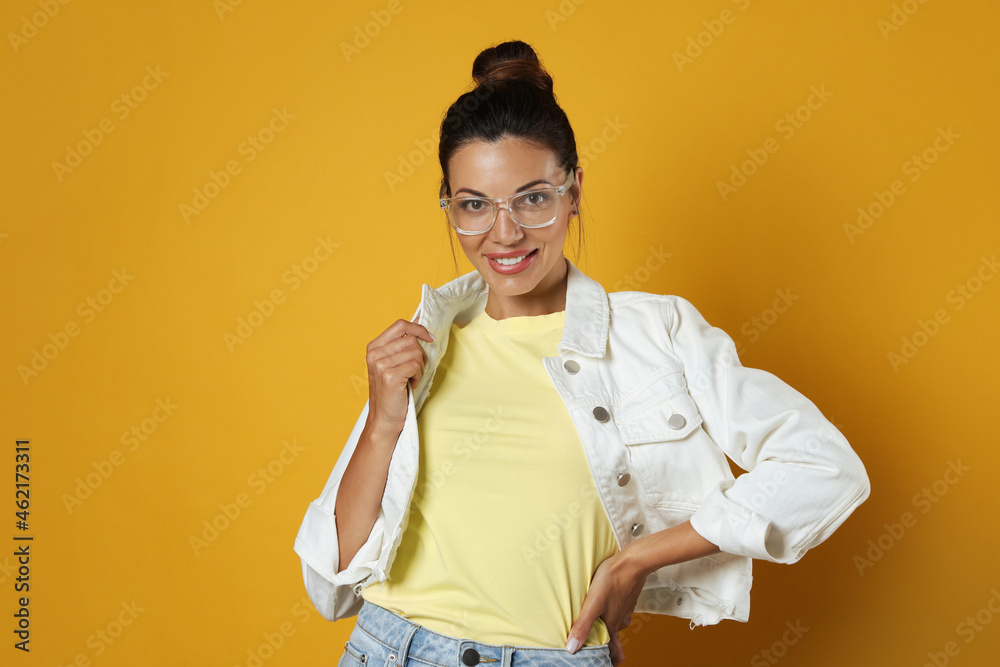 Beautiful woman in eyeglasses on yellow background Beautiful woman in eyeglasses on yellow background